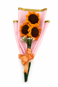 Golden Sunshine Handcrafted Crochet Sunflower Bouquet – three golden crochet sunflowers in blush-pink wrap with orange satin bow