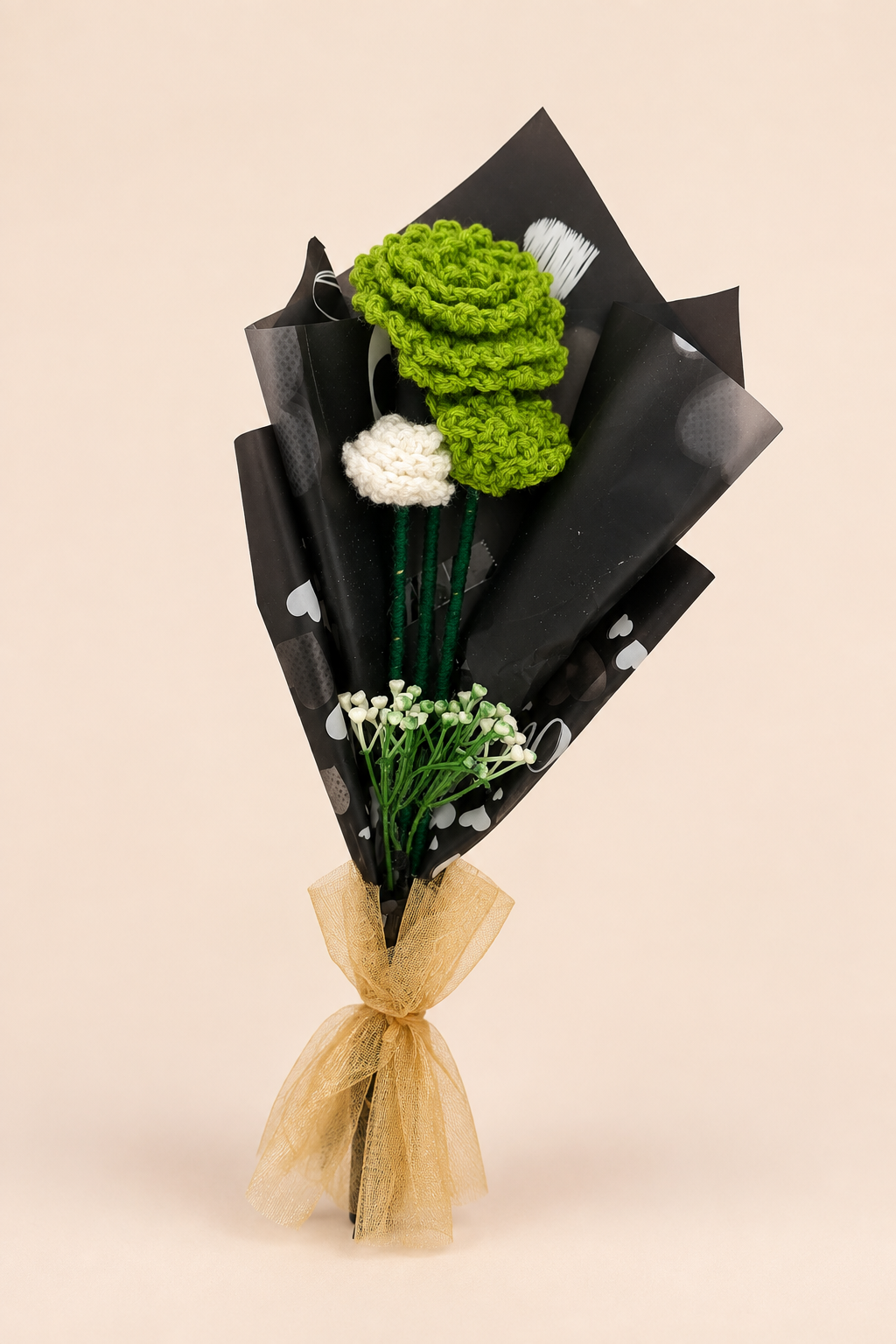 Emerald Elegance Handcrafted Crochet Bouquet – olive-green crochet rose and white carnation in black heart-print wrap with golden tulle bow
