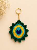 Royal Plume Handcrafted Crochet Peacock Feather Keychain – lifestyle shot on beige handbag