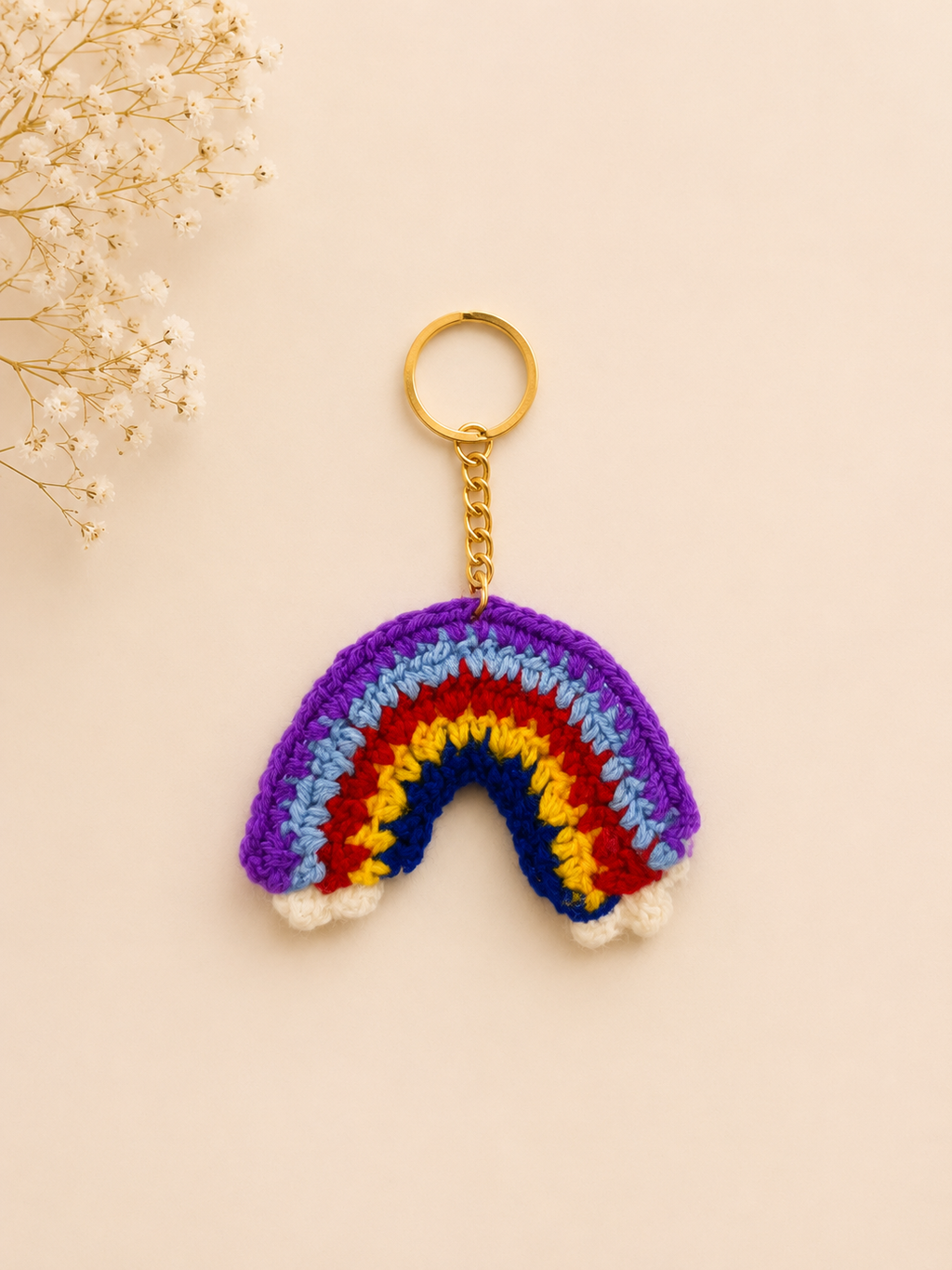 Rainbow Delight Handcrafted Crochet Keychain – flat lay showing vibrant rainbow arch with white cloud base