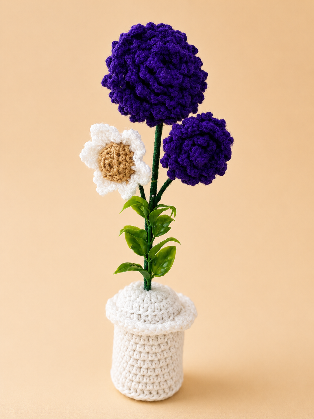 Royal Harmony Handcrafted Crochet Flower Pot Keepsake with purple pom-pom blooms and white daisy in a white crochet pot