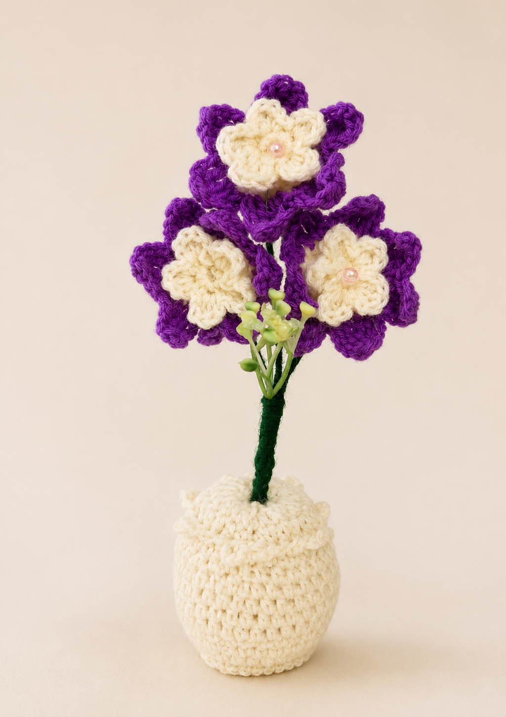 Amethyst Grace Handcrafted Crochet Floral Keepsake with purple and cream blooms and pearl centres in a cream crochet vase
