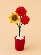 Sunlit Romance Handcrafted Crochet Rose and Sunflower Keepsake with crimson roses and golden sunflower in a red crochet pot
