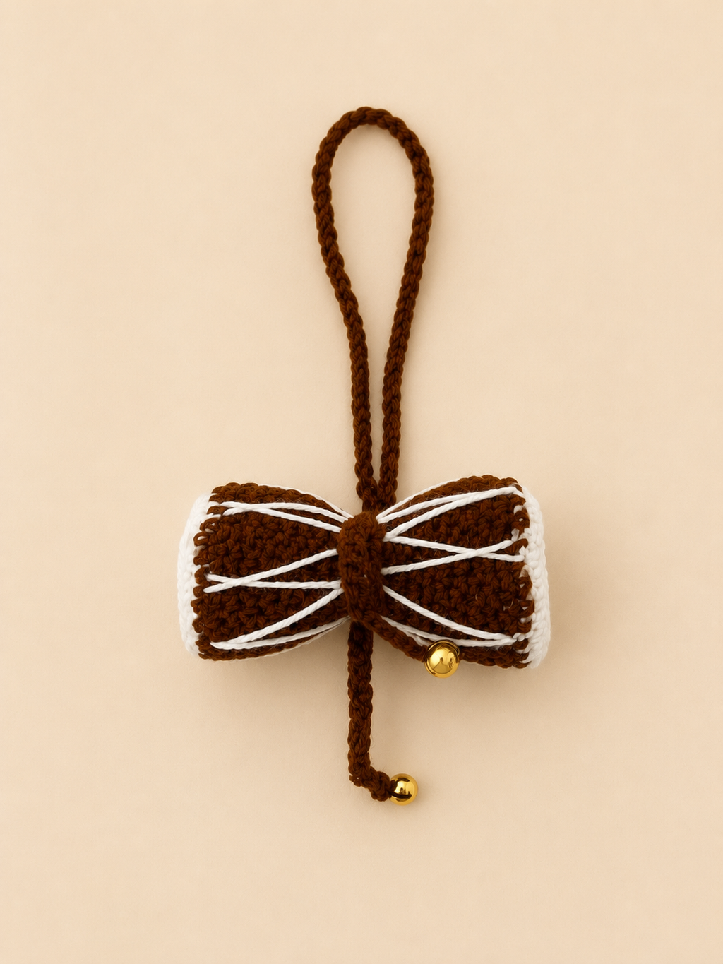 Divine Rhythm handcrafted crochet Damru car hanging in chocolate brown with gold bells