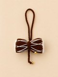 Divine Rhythm handcrafted crochet Damru car hanging in chocolate brown with gold bells