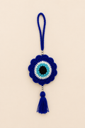 Guardian Gaze handcrafted crochet evil eye hanging in royal blue with silver beads and tassel