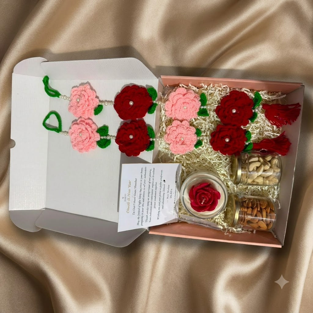 Diwali Gift Hamper Premium with Door Hangings showing a scented rose candle, two crochet flower door hangings, dry-fruit jars, and greeting card