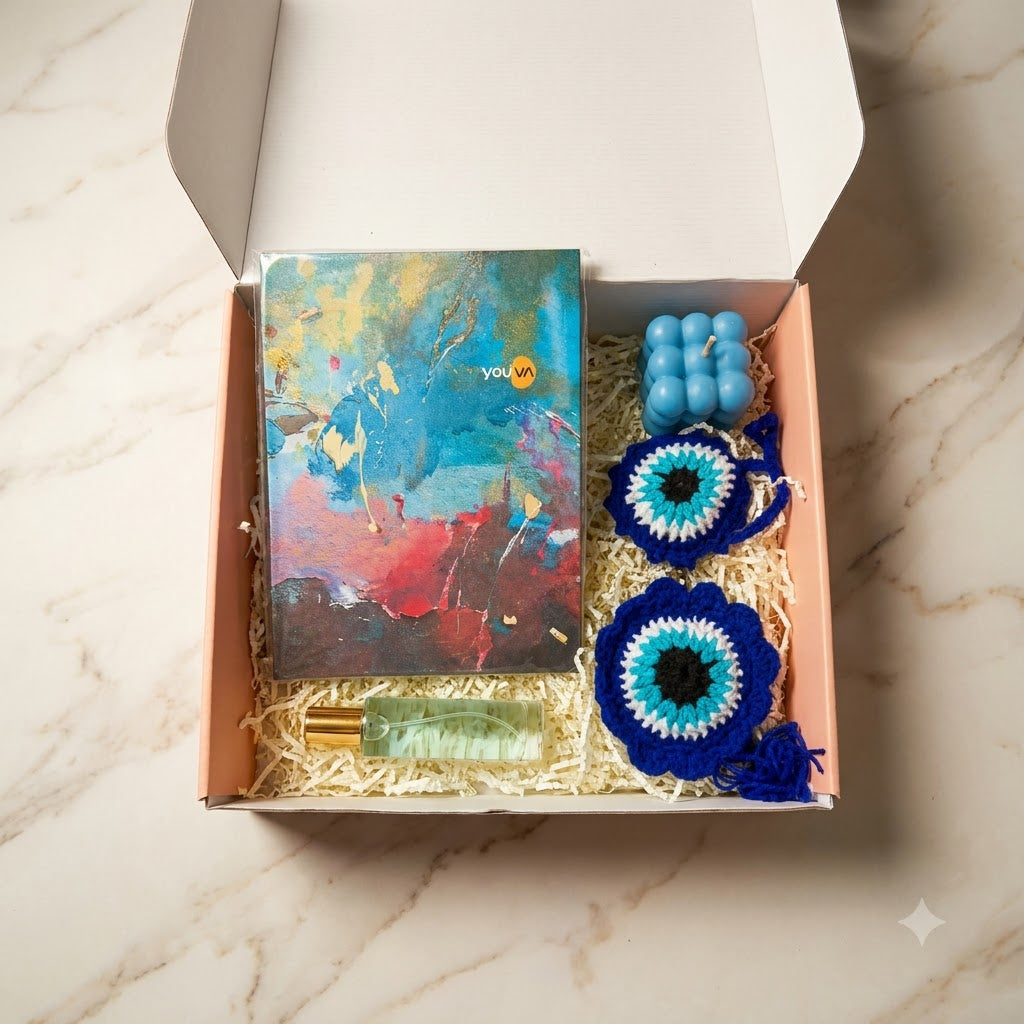 Diwali Gift Hamper with Fragrance showing a diary, blue scented bubble candle, premium perfume, and greeting card