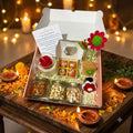 Premium Diwali Gift Hamper with Rose Candle and Keepsake presented with dry-fruit jars, mithai candles, floral bouquet charm, and greeting card