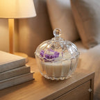 Premium scented purple daisy soy candle in a clear glass jar styled in an elegant home setting