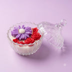 Premium scented purple flower and red rose soy candle in a clear glass jar with lid