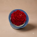 Premium scented red rose soy candle in a colourful blue jar